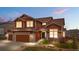 Inviting two-story home features a two-car garage, and well-maintained landscaping at 3234 El Charro Pt, Castle Rock, CO 80108
