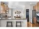 Kitchen with stainless refrigerator, granite counters, breakfast bar and view of dining area at 3234 El Charro Pt, Castle Rock, CO 80108