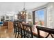Modern open-concept kitchen and dining area with a central island, hardwood floors, and large windows at 3234 El Charro Pt, Castle Rock, CO 80108