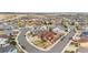 Wide aerial shot showcases a suburban neighborhood, diverse homes, winding streets, and open spaces at 3234 El Charro Pt, Castle Rock, CO 80108