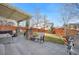 Relaxing backyard patio with a pergola, stone pillars, outdoor furniture, BBQ, and a small lawn at 3234 El Charro Pt, Castle Rock, CO 80108