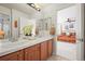 Bathroom with double sinks and views into the bedroom at 6462 S Versailles Ct, Aurora, CO 80016