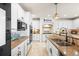 Modern kitchen with stainless steel appliances, white cabinetry, and granite countertops at 6462 S Versailles Ct, Aurora, CO 80016