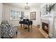 Elegant living room with a fireplace, a piano, and hardwood floors, perfect for entertaining guests at 6462 S Versailles Ct, Aurora, CO 80016