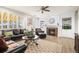 Cozy living room with comfortable seating, built-in shelves, a fireplace, and large windows at 6462 S Versailles Ct, Aurora, CO 80016