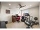 Bright office space with a ceiling fan, computer desk, and a treadmill at 6462 S Versailles Ct, Aurora, CO 80016