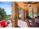 Covered outdoor patio with stone pillars, a fire pit, and plenty of seating at 6462 S Versailles Ct, Aurora, CO 80016
