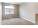 Empty bedroom includes carpet and a large window with a rooftop view at 10305 Martin Luther King Blvd, Denver, CO 80238