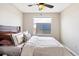 Bedroom showcases a ceiling fan, neutral walls, carpet, and window overlooking rooftop solar panels at 10305 Martin Luther King Blvd, Denver, CO 80238