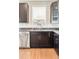 Close up of a kitchen featuring dark cabinets, stainless steel appliances, and granite countertops at 10305 Martin Luther King Blvd, Denver, CO 80238