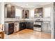 Well-equipped kitchen with stainless steel appliances, dark cabinetry, and ample counter space at 10305 Martin Luther King Blvd, Denver, CO 80238