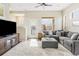 Cozy living room with plush rug, gray sofa, and large windows offering ample sunlight at 10305 Martin Luther King Blvd, Denver, CO 80238