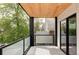 Outdoor balcony area with a modern ceiling, black columns, and glass railings at 425 S Pearl St, Denver, CO 80209