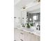 Well-lit bathroom featuring double sinks, contemporary faucets, and a large mirror at 425 S Pearl St, Denver, CO 80209