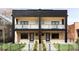 Modern two-story duplex with brick facade, black accents, and private balconies at 425 S Pearl St, Denver, CO 80209