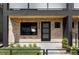 Modern brick home with black framed windows and front door that has decorative glass panels at 425 S Pearl St, Denver, CO 80209