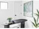 Bright home office featuring a sleek black desk, stylish decor, and ample natural light at 425 S Pearl St, Denver, CO 80209