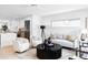 Bright living room featuring stylish seating, a black round coffee table, and light wood floors at 425 S Pearl St, Denver, CO 80209