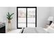Bright main bedroom features a modern ceiling fan, large sliding door, and designer decor at 425 S Pearl St, Denver, CO 80209