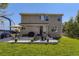 Spacious backyard with a patio dining set, grill, mature trees, and a well maintained lawn at 5090 Miriam Ln, Parker, CO 80134
