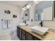 Bright primary bathroom with granite counters, dual sinks, modern fixtures and decorative mirrors at 5090 Miriam Ln, Parker, CO 80134