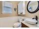 Stylish half-bath featuring updated sink, white wainscoting, modern toilet and decor at 5090 Miriam Ln, Parker, CO 80134