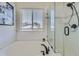 Bright and well-lit bathroom featuring a soaking tub, stand up shower with clear glass door and subway tile at 5090 Miriam Ln, Parker, CO 80134