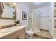 Bright bathroom featuring a white vanity, framed mirror, and a glass enclosed corner shower at 5090 Miriam Ln, Parker, CO 80134
