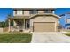 Charming two-story home featuring a covered porch and a two-car garage at 5090 Miriam Ln, Parker, CO 80134