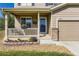 Close-up of the front porch with swing and well landscaped flower beds at 5090 Miriam Ln, Parker, CO 80134