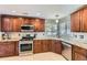 Well-lit kitchen features stainless steel appliances, granite countertops and plentiful wood cabinetry at 5090 Miriam Ln, Parker, CO 80134