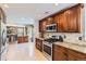 Modern kitchen with stainless appliances, granite counters and hardwood cabinets adjoining dining area at 5090 Miriam Ln, Parker, CO 80134