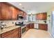 Well-equipped kitchen featuring stainless steel appliances and stone countertops at 5090 Miriam Ln, Parker, CO 80134