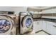 Well-equipped laundry room with sleek silver washer and dryer, and cabinets with stylish countertops at 5090 Miriam Ln, Parker, CO 80134