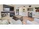 Bright living room featuring hardwood floors, a fireplace, and stylish furniture at 5090 Miriam Ln, Parker, CO 80134