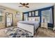 Comfortable main bedroom featuring ample natural light, ceiling fan, plush carpet and ensuite bathroom at 5090 Miriam Ln, Parker, CO 80134