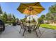 Outdoor patio area with a dining set and shade umbrella, perfect for entertaining in the backyard at 5090 Miriam Ln, Parker, CO 80134