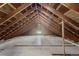 Unfinished attic with exposed rafters and wooden beams, offering potential for customization at 7801 Valley View St, Louviers, CO 80131