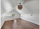 Well-lit attic space featuring a window and sleek hardwood floors, perfect for storage or a bonus room at 7801 Valley View St, Louviers, CO 80131