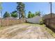 Open backyard area with partial view of a shed and a fence, suitable for parking or landscaping at 7801 Valley View St, Louviers, CO 80131