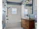 Bathroom featuring a decorative tiled floor, blue walls, and a vanity made out of a dresser at 7801 Valley View St, Louviers, CO 80131
