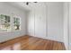 Bright bedroom with hardwood floors, white walls, and large windows offering plenty of natural light at 7801 Valley View St, Louviers, CO 80131