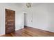 Bedroom with hardwood floors, neutral walls, period lighting, and decorative trim at 7801 Valley View St, Louviers, CO 80131