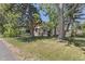 Charming single story home with a red roof, covered porch and well-maintained landscaping at 7801 Valley View St, Louviers, CO 80131