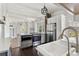 Bright open floor plan from kitchen to dining with a white farmhouse sink and stainless steel appliances at 7801 Valley View St, Louviers, CO 80131