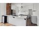 Modern kitchen with white cabinets, stainless steel appliances, and a large island at 7801 Valley View St, Louviers, CO 80131