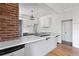 Modern kitchen with white cabinets, stainless steel appliances, a large island, and white subway tile backsplash at 7801 Valley View St, Louviers, CO 80131