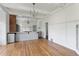 Bright open floor plan from dining to kitchen with a kitchen island and white subway tile backsplash at 7801 Valley View St, Louviers, CO 80131