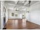 Spacious living room featuring hardwood floors, white walls, large windows, and abundant natural light at 7801 Valley View St, Louviers, CO 80131