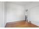 Spacious living room featuring hardwood floors and white walls, creating a bright and airy atmosphere at 7801 Valley View St, Louviers, CO 80131